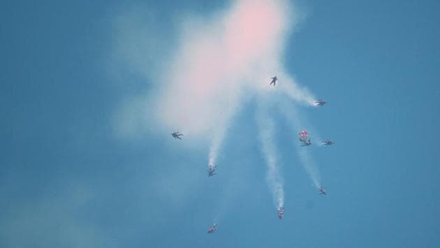 Members of the Red Lions parachute team participate in the 54th National Day Parade in Singapore. (Roslan Rahman / AFP)