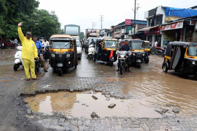 The potholes on the stretch were filled with stones but they were washed away in the rain. (HT Photo) The potholes on the stretch were filled with stones but they were washed away in the rain. (HT Photo)