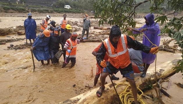 NDRF personnel help move flood victims to safer areas in Wayanad district in Kerala.(AP)