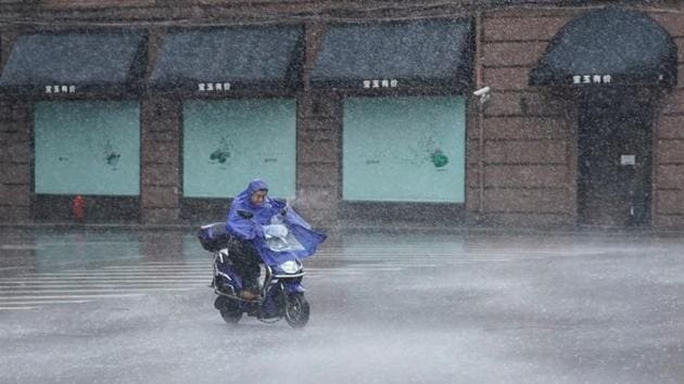 A man rides an electric scooter in the rainstorm as typhoon Lekima approaches in Shanghai. The monster storm made landfall in the early hours in Wenling City, packing winds of 187 kilometres per hour (116 miles per hour), and was expected to churn up the east coast towards Shanghai, Xinhua added. (Aly Song / REUTERS)
