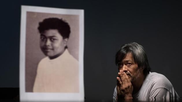 Mark Apuron, 45, sits beside a photo of himself when he was 15 years old, the age when he says he was raped by his uncle, former Archbishop Anthony Apuron at the rectory, in Hagatna, Guam. “Everything happened so fast,” he recalls. “But that one second, for me, it never stops.” He never found the right words to tell his parents what happened. “I didn’t think I would be believed,” he said, tearing up. (David Goldman / AP) Mark Apuron, 45, sits beside a photo of himself when he was 15 years old, the age when he says he was raped by his uncle, former Archbishop Anthony Apuron at the rectory, in Hagatna, Guam. “Everything happened so fast,” he recalls. “But that one second, for me, it never stops.” He never found the right words to tell his parents what happened. “I didn’t think I would be believed,” he said, tearing up. (David Goldman / AP)