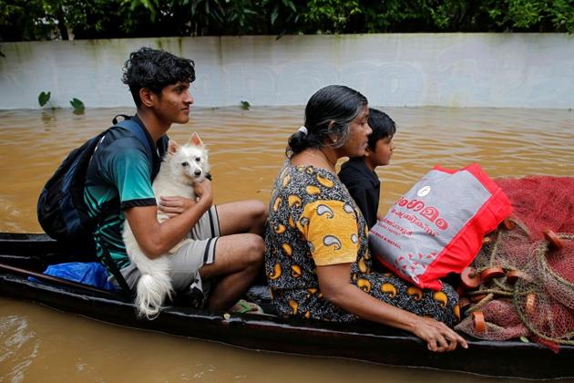 A flood-affected boy carries his dog as he and others are moved to a safer place in Paravur in Ernakulam district in Kerala, August 9, 2019. (REUTERS) A flood-affected boy carries his dog as he and others are moved to a safer place in Paravur in Ernakulam district in Kerala, August 9, 2019. (REUTERS)