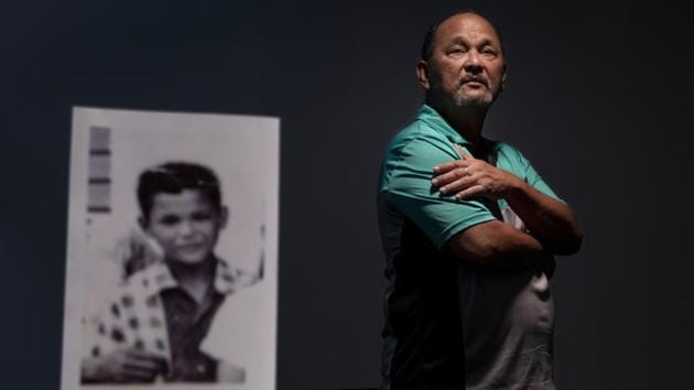 Ramon De Plata, 65, stands behind a photo of himself when he was about 10 years old, the age when he says he walked into Father Antonio Cruz’s bedroom and saw Cruz and his protege, seminarian Anthony Apuron, engaged in sex acts with a boy from his school. “He was calling me to join them,” recounted De Plata. “It really messed me up growing up. I became hostile in school. I didn’t trust my teachers anymore.” (David Goldman / AP) Ramon De Plata, 65, stands behind a photo of himself when he was about 10 years old, the age when he says he walked into Father Antonio Cruz’s bedroom and saw Cruz and his protege, seminarian Anthony Apuron, engaged in sex acts with a boy from his school. “He was calling me to join them,” recounted De Plata. “It really messed me up growing up. I became hostile in school. I didn’t trust my teachers anymore.” (David Goldman / AP)