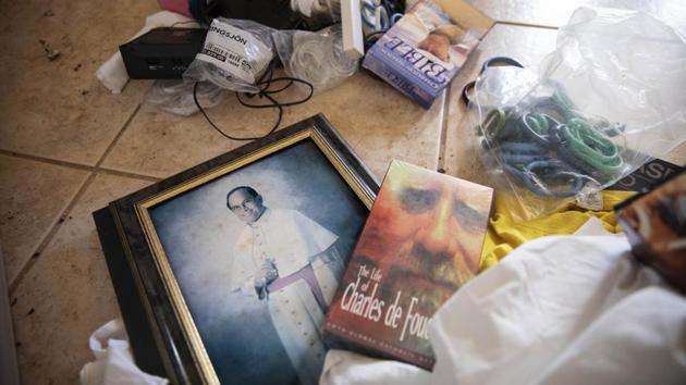 A photo of former Archbishop Anthony Apuron lays among discarded items on the floor of the former Accion Hotel which was a seminary but is now vacant and for sale by the Catholic Church, in Yona, Guam. In April the Vatican revealed that Pope Francis had upheld the findings of a secret church trial that found Apuron guilty of sex crimes against children. Anthony Apuron denies the allegations, which are detailed in lawsuits. (David Goldman / AP) A photo of former Archbishop Anthony Apuron lays among discarded items on the floor of the former Accion Hotel which was a seminary but is now vacant and for sale by the Catholic Church, in Yona, Guam. In April the Vatican revealed that Pope Francis had upheld the findings of a secret church trial that found Apuron guilty of sex crimes against children. Anthony Apuron denies the allegations, which are detailed in lawsuits. (David Goldman / AP)