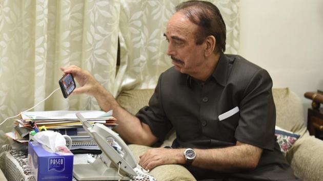 Senior Congress leader Ghulam Nabi Azad watching Prime Minister Narendra Modi’s address on a journalist’s phone, in New Delhi. Azad was stopped at the Srinagar International airport on Thursday morning and sent back to Delhi by the local administration. He was accompanied by state Congress chief GA Mir. (Raj K Raj / HT Photo) Senior Congress leader Ghulam Nabi Azad watching Prime Minister Narendra Modi’s address on a journalist’s phone, in New Delhi. Azad was stopped at the Srinagar International airport on Thursday morning and sent back to Delhi by the local administration. He was accompanied by state Congress chief GA Mir. (Raj K Raj / HT Photo)