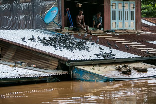 Residents look out from a window as floodwaters submerged areas of Ye township in Mon State. Myanmar troops and emergency responders scrambled to provide aid in flood-hit parts of the country Sunday after rising waters forced residents to flee by boat and a landslide killed at least 52 people. (Sai Aung Main / AFP) Residents look out from a window as floodwaters submerged areas of Ye township in Mon State. Myanmar troops and emergency responders scrambled to provide aid in flood-hit parts of the country Sunday after rising waters forced residents to flee by boat and a landslide killed at least 52 people. (Sai Aung Main / AFP)