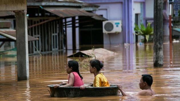 Residents use a plastic tub as floodwaters submerged areas of Ye township in Mon State. Every year monsoon rains hammer Myanmar and other countries across Southeast Asia, submerging homes, displacing residents and triggering landslides. But this season’s deluge has tested disaster response after a fatal landslide on Friday in southeastern Mon state was followed by heavy flooding that reached the roofs of houses and treetops in nearby towns. (Sai Aung Main / AFP) Residents use a plastic tub as floodwaters submerged areas of Ye township in Mon State. Every year monsoon rains hammer Myanmar and other countries across Southeast Asia, submerging homes, displacing residents and triggering landslides. But this season’s deluge has tested disaster response after a fatal landslide on Friday in southeastern Mon state was followed by heavy flooding that reached the roofs of houses and treetops in nearby towns. (Sai Aung Main / AFP)