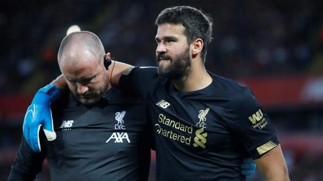 Liverpool's Alisson is helped off the pitch as he is substituted after sustaining an injury.(REUTERS)