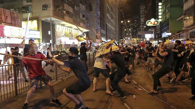 Some protesters blocked the streets for long hours and impeded traffic; some radical ones even stormed the Hong Kong Legislative Council building, destroyed public facilities, attacked the police with petrol bombs and damaged the national flag of China(AP)