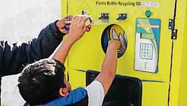 A child tries the ‘reverse vending machine’.(HT Photo)