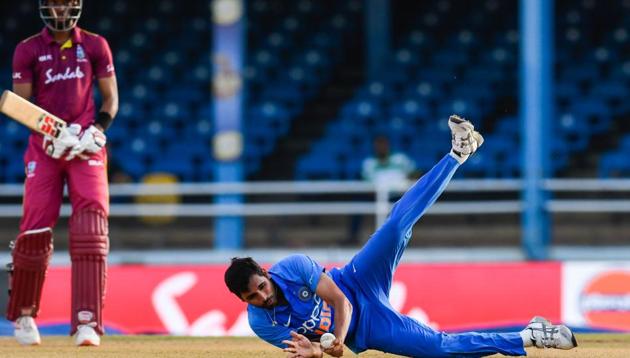 Bhuvneshwar Kumar (R) of India takes the catch to dismiss Roston Chase.(AFP)