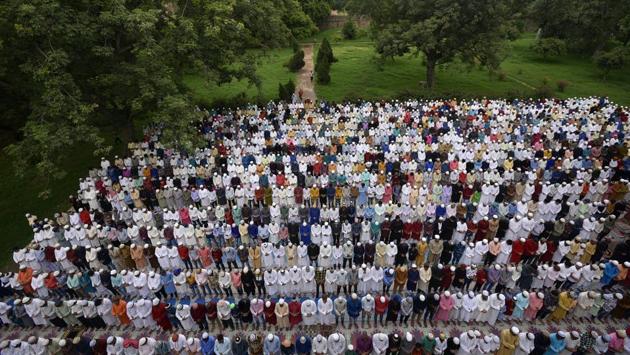 People pray while celebrating the Eid al-Adha festival at Humayun’s Tomb in New Delhi. People mark Eid by buying tens of thousands of sheep and goats to kill in an annual ritual that stems from the story of the prophet Abraham, commanded by God to slaughter his beloved son Ismail. The Almighty replaced Ismail with a sheep just as Ibrahim was about to sacrifice him. (Biplov Bhuyan / HT Photo)