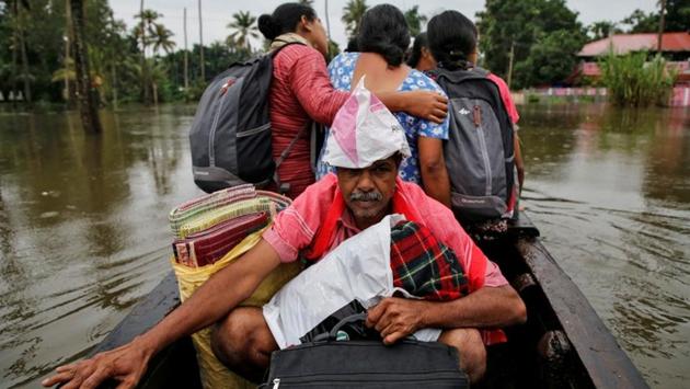 Flood-affected people are moved to a safer place at Paravur in Ernakulam district. The Indian Meteorological Department (IMD) has issued a red alert for Kannur, Kasaragod and Wayanad in view of heavy rain forecast. (Sivaram V / REUTERS)