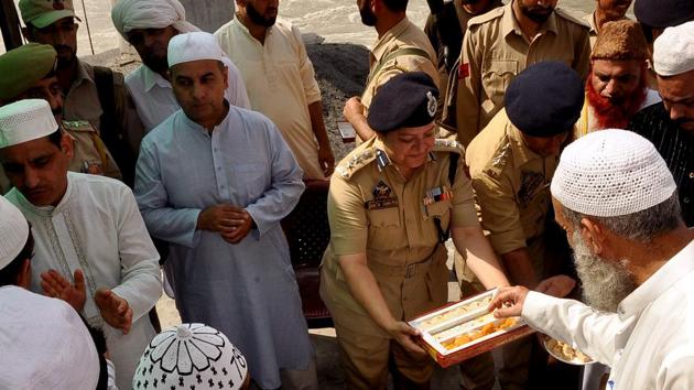 Police personnel offer sweets during the festival of Eid ul-Adha in Jammu on Monday. (ANI Photo)