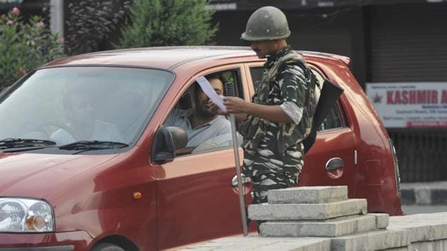 Paramilatary soldiers check documents during curfew on Eid al-Adha, at Down Town area, in Srinagar, Jammu and Kashmir, on Monday. (Photo by Waseem Andrabi / HT Photo)