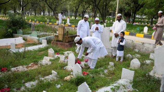 People place flowers on the graves of their loved ones after offering Eid al-Adha prayers in Hyderabad, Telangana. The imams’ or priests in the city offered ‘dua’ (supplication) for peace in the country, especially in Jammu and Kashmir, where restrictions are in force following scrapping of Article 370. ‘Dua’ was also offered for the people of flood-hit Kerala, Karnataka and other states. (Noah Seelam / AFP)