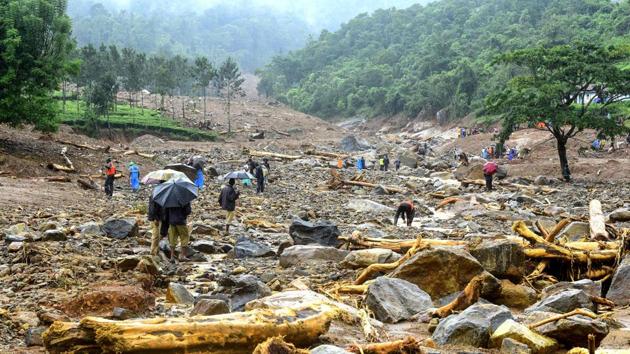 Volunteers, local residents and members of National Disaster Response Force (NDRF) search for survivors in the debris left by a landslide at Puthumala at Meppadi in the Wayanad district of the Indian state of Kerala on Saturday. (AFP)