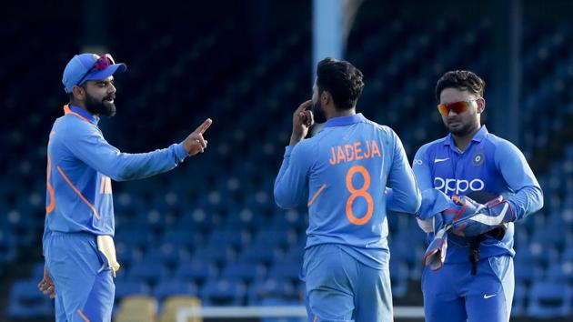 India's captain Virat Kohli, left, gives instruction to teammates Ravindra Jadeja. (AP)