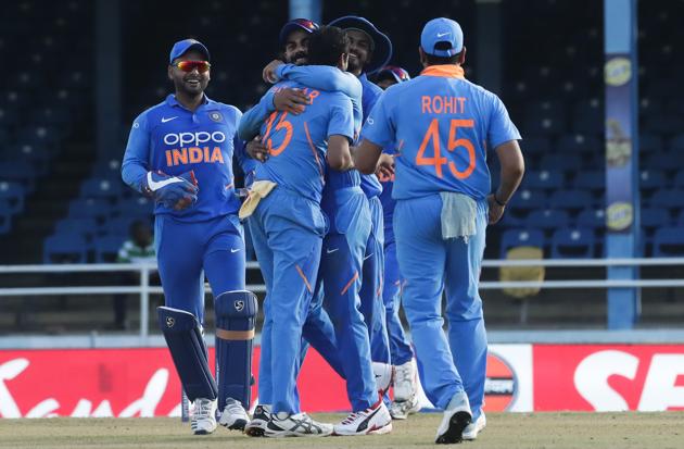 India bowler Bhuvneshwar Kumar, center, is hugged by captain Virat Kohli. (AP)