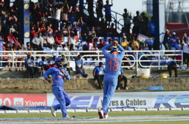 India's captain Virat Kohli, right, celebrates after taking the catch to dismiss West Indies Nicholas Pooran. (AP)