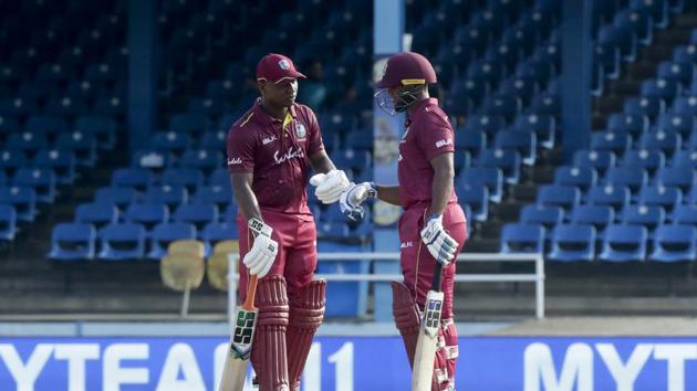 West Indies Evin Lewis, left, knocks his glove with batting partner Nicholas Pooran(AP)