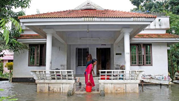 A woman clears out the water from her flooded house at Paravur on the outskirts of Kochi. Operations at the Cochin International Airport resumed on Sunday after a two-day break following the inundation of the runway area due to water from the nearby Periyar river entering the premises. (Sivaram V / REUTERS)