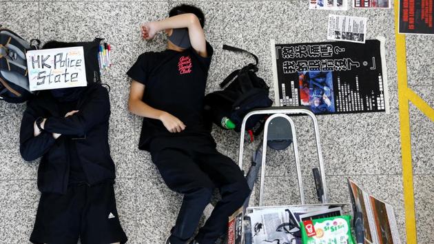 Protesters sleep on the floor during a demonstration at Hong Kong Airport. The 10 weeks of unrest, which has seen millions of people take to Hong Kong’s streets, has become the biggest challenge to Chinese rule of the semi-autonomous city since its 1997 handover from Britain. The protests began in opposition to a bill that would have allowed extraditions to the mainland, but quickly evolved into a broader bid to reverse a slide of rights and freedoms in the southern Chinese city. (Thomas Peter / REUTERS) Protesters sleep on the floor during a demonstration at Hong Kong Airport. The 10 weeks of unrest, which has seen millions of people take to Hong Kong’s streets, has become the biggest challenge to Chinese rule of the semi-autonomous city since its 1997 handover from Britain. The protests began in opposition to a bill that would have allowed extraditions to the mainland, but quickly evolved into a broader bid to reverse a slide of rights and freedoms in the southern Chinese city. (Thomas Peter / REUTERS)