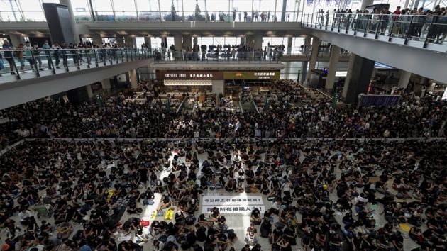 Demonstrators continued to gather in the main terminal building Tuesday, although the airport said normal operations had been restored. Thousands of black-clad demonstrators occupied the airport on Monday following a weekend of violence that saw police fire tear gas into a subway station and rubber bullets at close range. (Vincent Thian / AP) Demonstrators continued to gather in the main terminal building Tuesday, although the airport said normal operations had been restored. Thousands of black-clad demonstrators occupied the airport on Monday following a weekend of violence that saw police fire tear gas into a subway station and rubber bullets at close range. (Vincent Thian / AP)