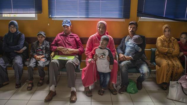 Families wait with their children affected by a rare disorder inside a hospital. There is a rumor about a new XP treatment. It is particularly challenging in developing countries, where an awareness of the disorder and access to treatments are scarce, and in poor, rural communities where people spend more time outside. (Mosa'ab Elshamy / AP)