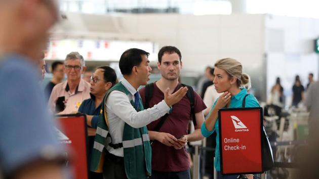 Passengers talk with a member of the airport staff after the announcement that all airport operations are suspended due to an anti-government demonstration at Hong Kong Airport, China August 13, 2019.(REUTERS)