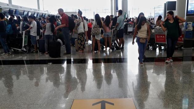 Passengers queue as the airport reopened a day after flights were halted due to a protest, at Hong Kong International Airport on Tuesday. (Reuters File Photo) Passengers queue as the airport reopened a day after flights were halted due to a protest, at Hong Kong International Airport on Tuesday. (Reuters File Photo)