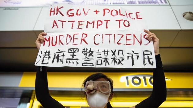 A demonstrator holds a placard during a protest at the Hong Kong International Airport in Hong Kong, China, on August 12, 2019. “Protesters have been frequently using extremely dangerous tools to attack the police in recent days, constituting serious crimes with sprouts of terrorism emerging,” said Hong Kong and Macau Affairs office spokesman Yang Guang in Beijing. (Kyle Lam / Bloomberg) A demonstrator holds a placard during a protest at the Hong Kong International Airport in Hong Kong, China, on August 12, 2019. “Protesters have been frequently using extremely dangerous tools to attack the police in recent days, constituting serious crimes with sprouts of terrorism emerging,” said Hong Kong and Macau Affairs office spokesman Yang Guang in Beijing. (Kyle Lam / Bloomberg)