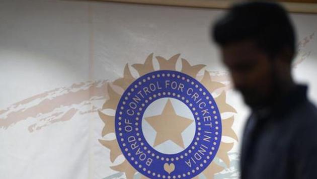 A man walks in front of the logo for the Board of Control for Cricket in India (BCCI). (AFP) A man walks in front of the logo for the Board of Control for Cricket in India (BCCI). (AFP)