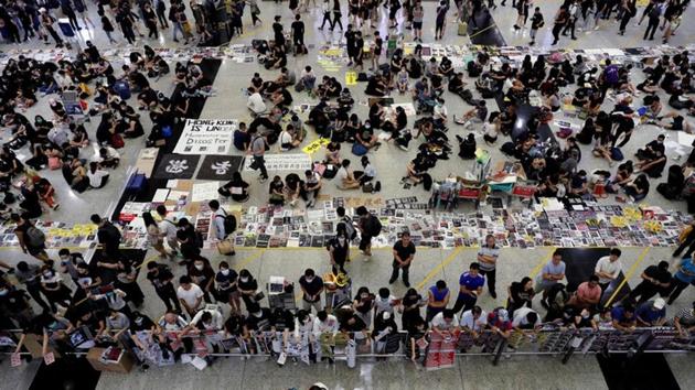 Anti-Extradition bill protesters distribute leaflets to passengers during a mass demonstration at the Hong Kong international airport, in Hong Kong (REUTERS) Anti-Extradition bill protesters distribute leaflets to passengers during a mass demonstration at the Hong Kong international airport, in Hong Kong (REUTERS)