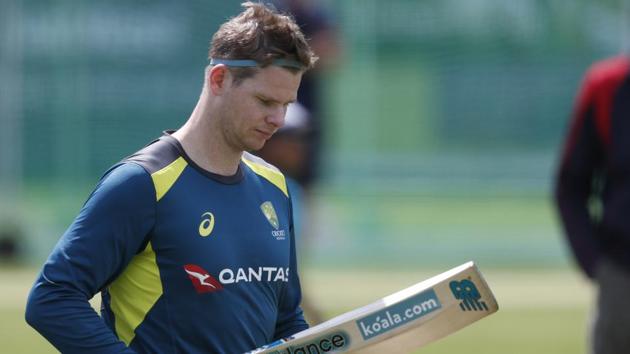 Australia's Steve Smith checks two of his cricket bats during a training session at Lord's cricket ground in London.(AP)