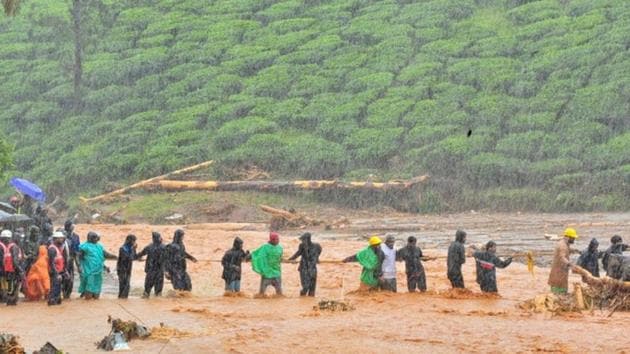 Rescuers help people to cross a flooded area after a landslide caused by torrential monsoon rains in Meppadi in Wayanad district in the southern Indian state of Kerala, August 9, 2019. (REUTERS) Rescuers help people to cross a flooded area after a landslide caused by torrential monsoon rains in Meppadi in Wayanad district in the southern Indian state of Kerala, August 9, 2019. (REUTERS)