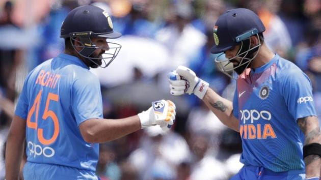 India's Rohit Sharma, left, bumps fist with Virat Kohli.(AP)