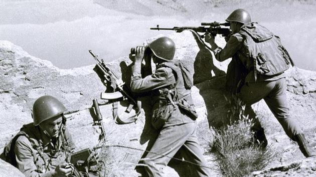 In this late April 1988, file photo, Soviet soldiers observe the highlands, while fighting Islamic guerrillas at an undisclosed location in Afghanistan.(AP file photo/Alexander Sekretarev)