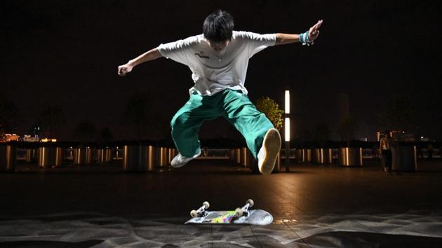 A boy practicing on a skateboard near the Shanghai Long Museum in Shanghai. Skateboarding will make its Olympic debut in Tokyo next year, but many in the growing scene in Shanghai complain that they have few places to go and are looked down upon as trouble-makers. Guan Kangrong travels more than one hour to visit a public skate park next to the Huangpu River, which runs through Shanghai. (HECTOR RETAMAL / AFP)