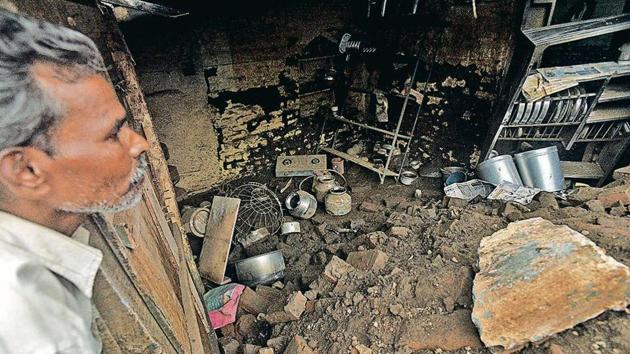 Vidyadhar Kamble, a flood survivor and resident of Shirti village in Sangli dejectedly looks at his house which has been destroyed in the recent floods.(Pratham Gokhale/Hindustan Times)