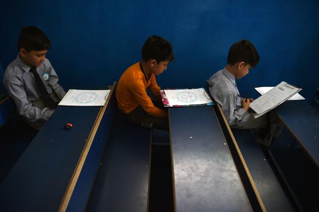 Afghan students take mid-term exams at a school in Kabul. The US and Taliban claim progress in ongoing peace talks, but little has changed for Afghans, and recent attacks underscore how children remain as vulnerable as ever in the grinding conflict. (WAKIL KOHSAR / AFP) Afghan students take mid-term exams at a school in Kabul. The US and Taliban claim progress in ongoing peace talks, but little has changed for Afghans, and recent attacks underscore how children remain as vulnerable as ever in the grinding conflict. (WAKIL KOHSAR / AFP)
