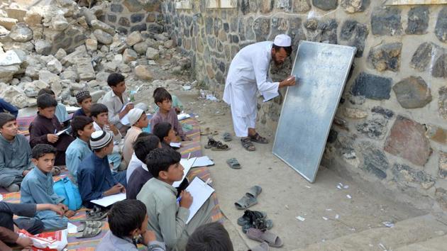 In the arid Deh Bala district of Nangarhar province in eastern Afghanistan, the Papen high school has been reduced to rubble amid fighting between government forces and the Islamic State group. Omar Ghorzang, a school district official, said the stress takes a huge toll. “When the teachers are talking to them, the kids talk among themselves and do bizarre things. They cannot pay attention”, Ghorzang said. (WAKIL KOHSAR / AFP) In the arid Deh Bala district of Nangarhar province in eastern Afghanistan, the Papen high school has been reduced to rubble amid fighting between government forces and the Islamic State group. Omar Ghorzang, a school district official, said the stress takes a huge toll. “When the teachers are talking to them, the kids talk among themselves and do bizarre things. They cannot pay attention”, Ghorzang said. (WAKIL KOHSAR / AFP)