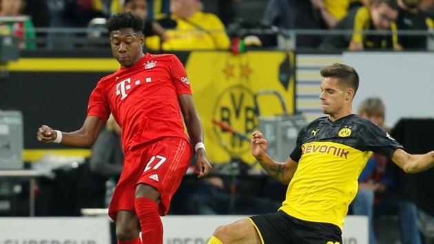 Bayern Munich's David Alaba in action with Borussia Dortmund's Julian Weigl.(REUTERS) Bayern Munich's David Alaba in action with Borussia Dortmund's Julian Weigl.(REUTERS)