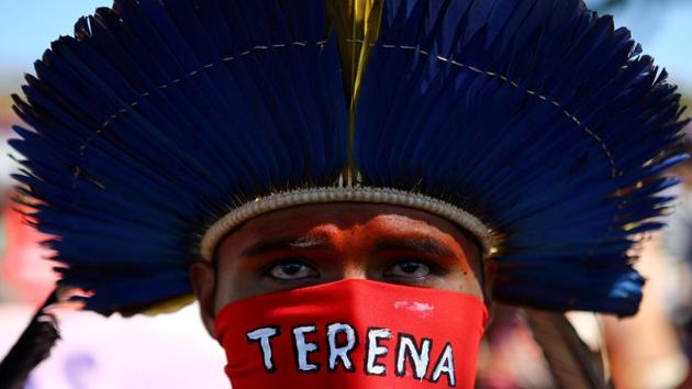 An indigenous man takes part in a march to demand respect for their rights and protest against Brazil's President Jair Bolsonaro and the policies of the federal government against indigenous people, in Brasilia, Brazil. (Andre Coelho / REUTERS) An indigenous man takes part in a march to demand respect for their rights and protest against Brazil's President Jair Bolsonaro and the policies of the federal government against indigenous people, in Brasilia, Brazil. (Andre Coelho / REUTERS)