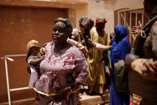 On the first day of one mission, in 40 degree Celsius (104 F), the French soldiers arrived in a hamlet 10km north of Ndaki town, next to a small wood where suspected jihadists had been seen fleeing earlier. They separated the women and children outside a thatched dome where camels chewed cud. They searched the men, took their smartphones and copied them onto a computer. One contained incriminating jihadist propaganda. (Benoit Tessier / REUTERS)