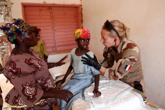 A member of a French military medical unit provides medical action for the benefit of the population during Operation Barkhane in Ndaki. “They want to talk to us but they are afraid,” Malian military police unit Captain Balassine said. “The other day we were talking to a young girl,” he continued. “First she lied. Then she said she was scared of talking because, after we leave, people will come and kill her.” (Benoit Tessier / REUTERS)