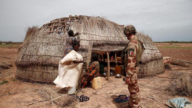 A French soldier conducts an area control operation. “We’re not going to resolve this in a day,” said David, the commander of the French forward base near the town of Gossi. (Benoit Tessier / REUTERS)