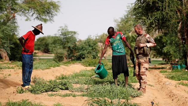 Commander David seen speaking to a vegetable grower as he conducts a Civil-Military Cooperation (CIMIC) patrolling during Operation Barkhane in Gossi. Operation Barkhane was launched in the wake of Operation Serval, a French offensive that pushed back Tuareg rebels and allied Islamists from northern Mali’s vast desert in 2013. It was launched in the wake of Operation Serval, a French offensive that pushed back Tuareg rebels and allied Islamists from northern Mali’s vast desert in 2013. (Benoit Tessier / REUTERS)