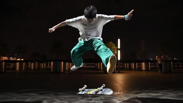 A boy practicing on a skateboard near the Shanghai Long Museum in Shanghai. Skateboarding will make its Olympic debut in Tokyo at the 2020 Olympic Games, but many in the growing scene in Shanghai complain that they have few places to go and are looked down upon as trouble-makers. (HECTOR RETAMAL / AFP) A boy practicing on a skateboard near the Shanghai Long Museum in Shanghai. Skateboarding will make its Olympic debut in Tokyo at the 2020 Olympic Games, but many in the growing scene in Shanghai complain that they have few places to go and are looked down upon as trouble-makers. (HECTOR RETAMAL / AFP)