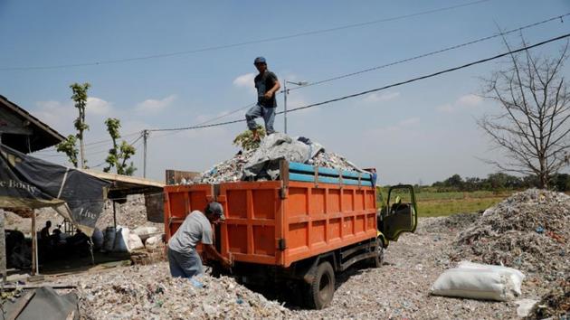 Heri Masud (L), a waste broker, prepares to unload rubbish from a truck at Bangun village in Mojokerto, East Java province, Indonesia. Overwhelmed by a spike in waste imports after China closed its doors to foreign garbage, Indonesia has tightened import rules and customs inspections, sending hundreds of tonnes of foreign waste back to their origin countries. (Willy Kurniawan / REUTERS) Heri Masud (L), a waste broker, prepares to unload rubbish from a truck at Bangun village in Mojokerto, East Java province, Indonesia. Overwhelmed by a spike in waste imports after China closed its doors to foreign garbage, Indonesia has tightened import rules and customs inspections, sending hundreds of tonnes of foreign waste back to their origin countries. (Willy Kurniawan / REUTERS)